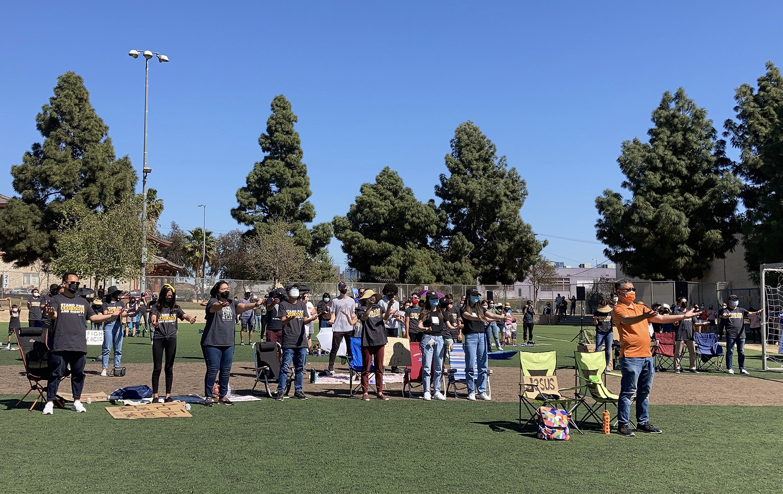 The Sunday, March 28, 2021, gathering at Seoul International Park in Los Angeles’ Koreatown resembled an outdoor church gathering with attendees sitting on lawn chairs and displaying signs that read “We Belong Here” and “Jesus Restores.” RNS photo by Alejandra Molina