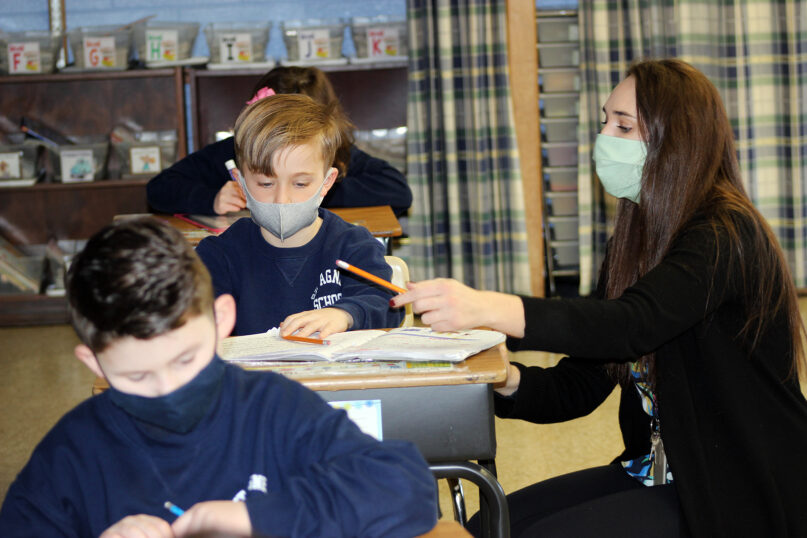 Shannon Brown helps students in her first-grade classroom at St. Agnes School in West Chester, Pennsylvania, Feb. 24, 2021. RNS photo by Elizabeth Evans