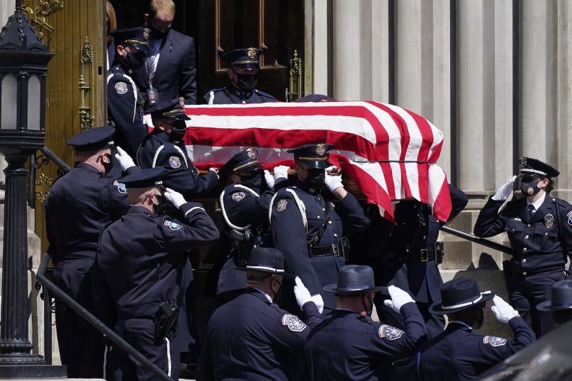 The casket carrying the body of fallen Boulder, Colorado, Police Department Officer Eric Talley is carried by a Denver police honor guard to a waiting hearse after a service at the Cathedral Basilica of the Immaculate Conception on March 29, 2021, in Denver. Talley and nine other people were killed March 22, during a mass shooting at a grocery store in Boulder. (AP Photo/David Zalubowski)