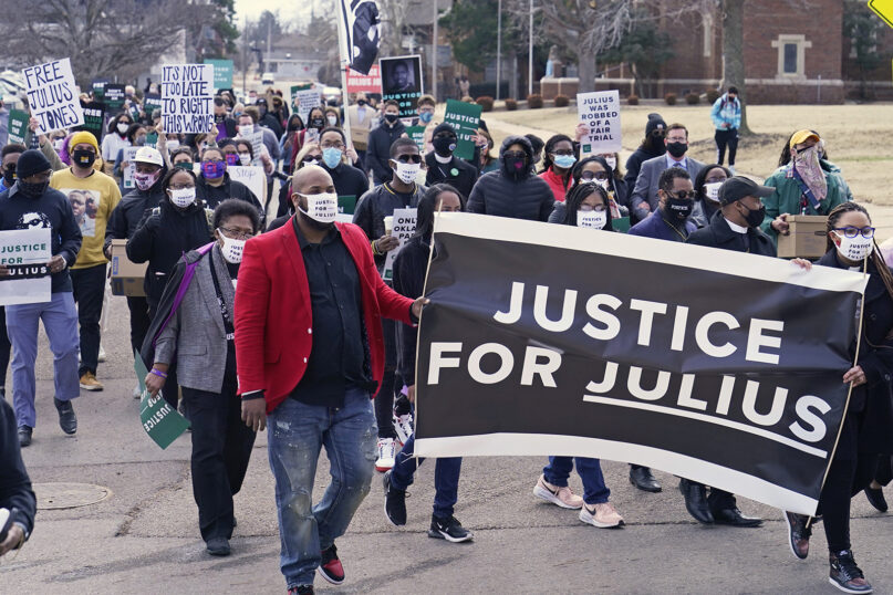 Supporters of Julius Jones, who has been on death row in Oklahoma for two decades, march to the offices of the Oklahoma Pardon and Parole Board, Thursday, Feb. 25, 2021, in Oklahoma City, where they presented a petition with over 6.2 million signatures, calling for Jones' death sentence to be commuted. (AP Photo/Sue Ogrocki)