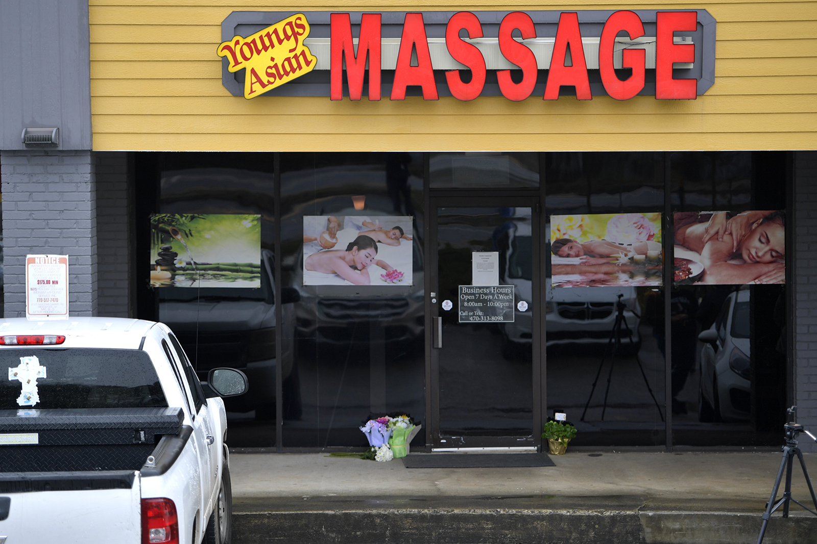 A makeshift memorial is seen outside a business where a multiple fatal shooting occurred on Tuesday, March 16, 2021, in Acworth, Ga. Robert Aaron Long, a white man, is accused of killing several people, most of whom were of Asian descent, at massage parlors in the Atlanta area. (AP Photo/Mike Stewart)