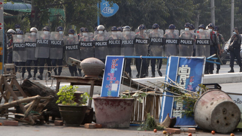 Myanmar riot police with shields move forward during a protest against the military coup in Mandalay, Myanmar, Sunday, Feb. 28, 2021. (AP Photo)
