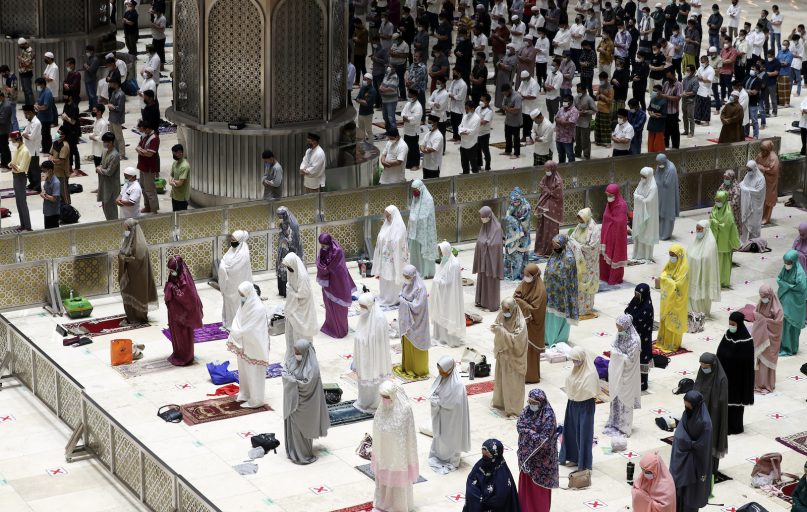 Indonesian Muslims pray while practicing social distancing to curb the spread of the novel coronavirus during an evening prayer called tarawih as they mark the first eve of the holy fasting month of Ramadan at Istiqlal Mosque in Jakarta, Indonesia, on April 12, 2021. During Ramadan, the holiest month in the Islamic calendar, Muslims refrain from eating, drinking, smoking and sex from dawn to dusk. (AP Photo/ Achmad Ibrahim)
