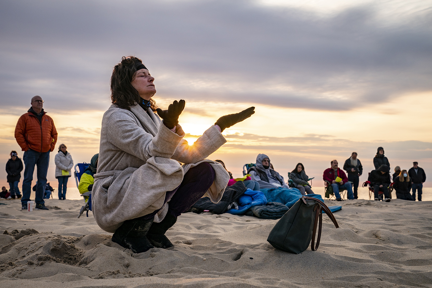 Parishioners gather on a beach for an Easter Sunday service at sunrise hosted by Hope Community Church of Manasquan, Sunday, April 4, 2021, in Manasquan, N.J. (AP Photo/John Minchillo)