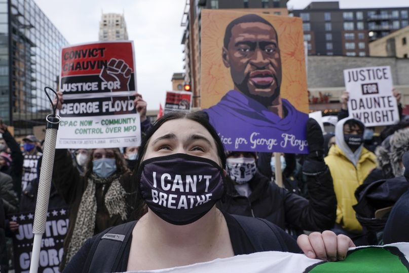 Protesters rally outside Minneapolis' 3rd Precinct on April 19, 2021, as the murder trial against former Minneapolis police Officer Derek Chauvin in the killing of George Floyd advances to jury deliberations. (AP Photo/Morry Gash)