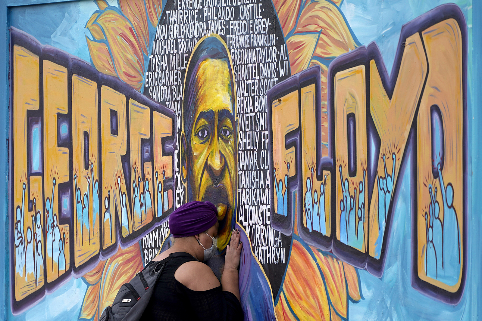 Damarra Atkins pays her respects to George Floyd at a mural at George Floyd Square on April 23, 2021, in Minneapolis. (AP Photo/Julio Cortez)