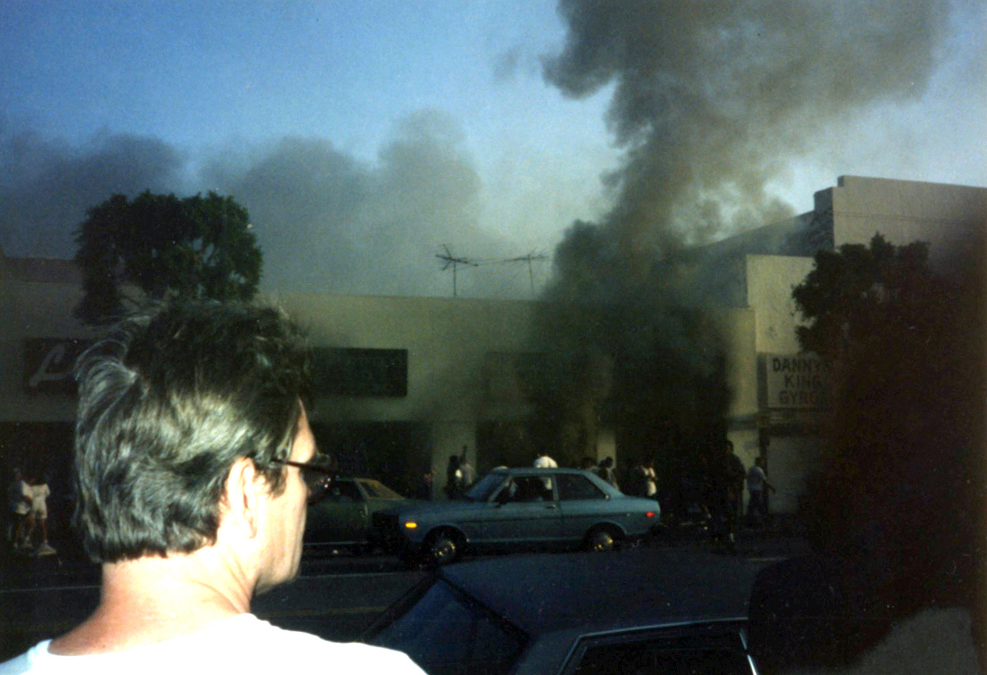 Smoke rises from a building set on fire on Hollywood Blvd. during riots in Los Angeles in April 1992. Photo by Ricky Bonilla/Creative Commons