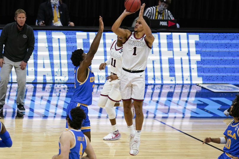 Gonzaga guard Jalen Suggs (1) shoots over UCLA guard David Singleton (34) to win the game during overtime in a men's Final Four NCAA college basketball tournament semifinal game, Saturday, April 3, 2021, at Lucas Oil Stadium in Indianapolis. Gonzaga won 93-90. (AP Photo/Michael Conroy)