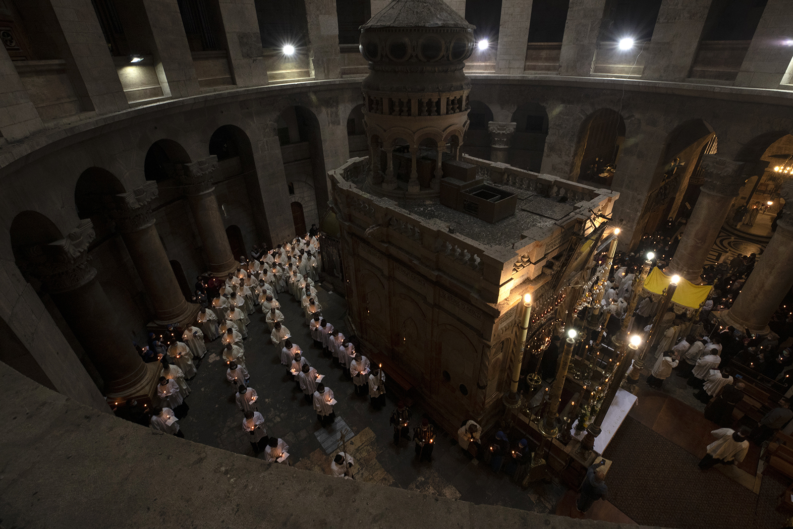 Priests circle the Holy Sepulchre during Holy Thursday mass led by the Latin Patriarch in the Old City of Jerusalem, Thursday, April 1, 2021. (AP Photo/Maya Alleruzzo)
