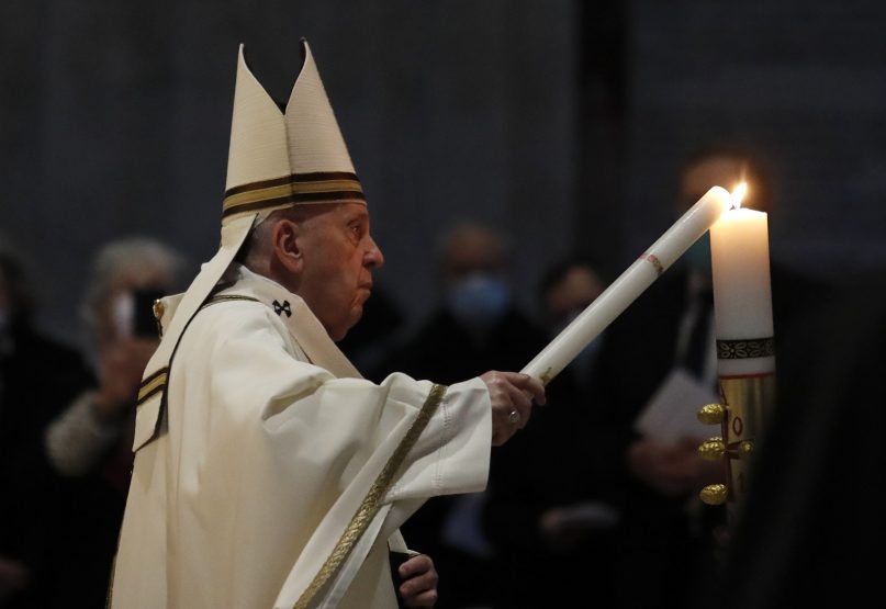 Pope Francis celebrates the Easter Vigil in St. Peter's Basilica as coronavirus pandemic restrictions stay in place for a second year running, at the Vatican, Saturday, April 3, 2021. (Remo Casilli/Pool photo via AP)