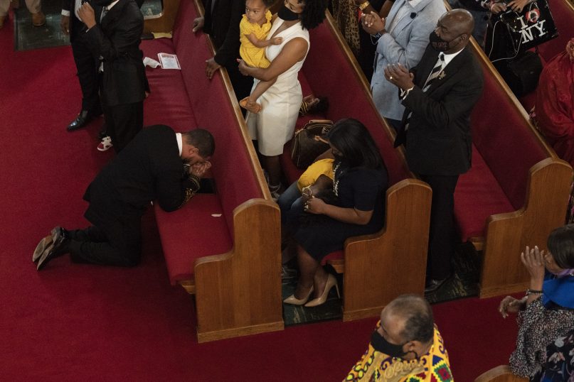 Rev. John R. Faison, Sr. kneels in prayer after preaching at a joint service for the centennial of the Tulsa Race Massacre at First Baptist Church of North Tulsa, Sunday, May 30, 2021, in Tulsa, Okla. (AP Photo/John Locher)