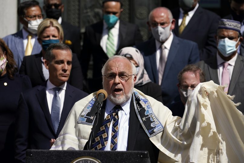 Rabbi Abraham Cooper, center, of the Simon Wiesenthal Center, speaks in front of civic and faith leaders outside City Hall, Thursday, May 20, 2021, in Los Angeles. (AP Photo/Marcio Jose Sanchez)