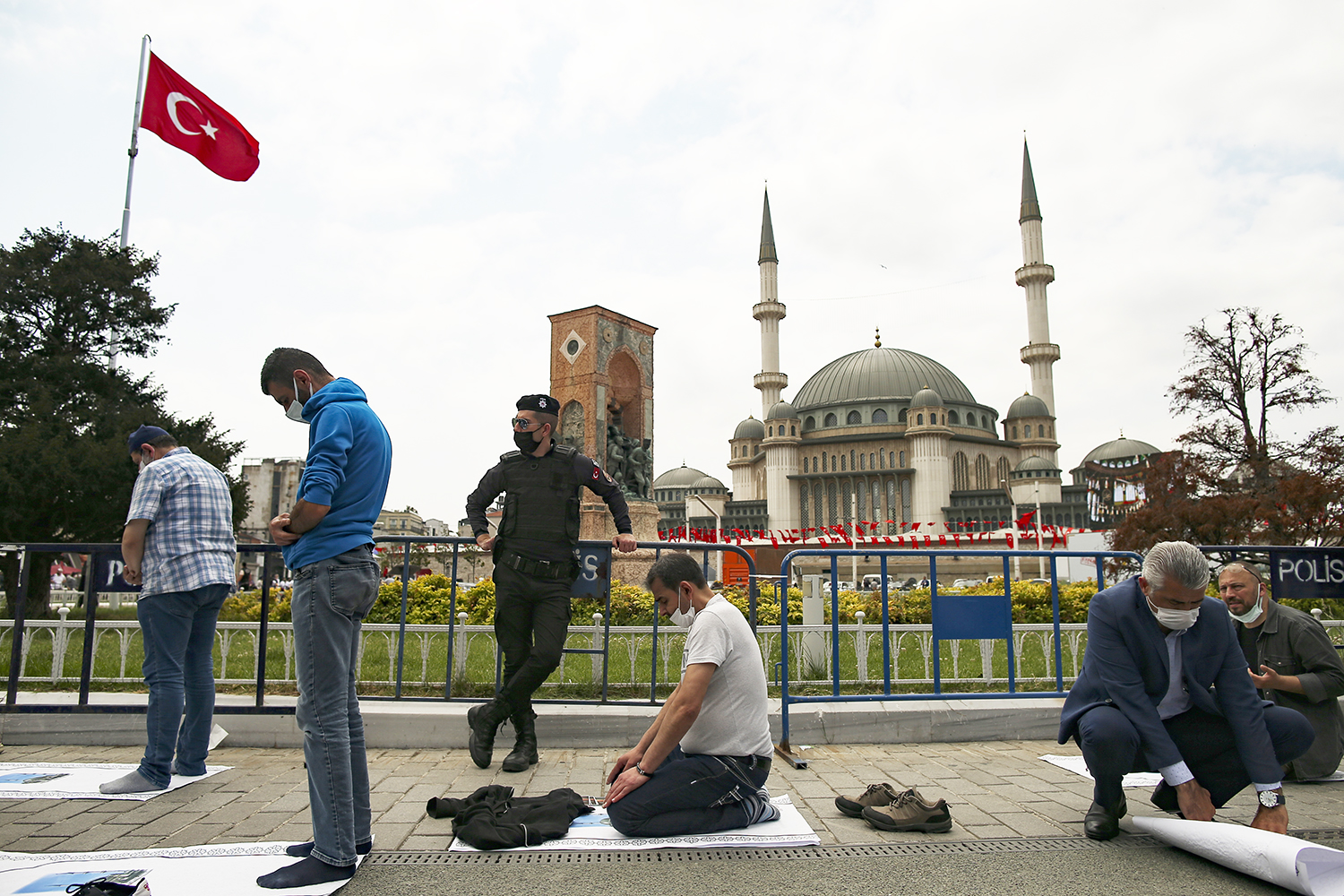 People pray outside the newly built Taksim Mosque at the Taksim Square in Istanbul, Friday, May 28, 2021. Turkish President Recep Tayyip Erdogan inaugurated landmark mosque in Istanbul's Taksim Square, fulfilling a long-time ambition to build a Muslim house of worship at the city's main public space that has become an emblem of the modern Turkish Republic. (AP Photo/Emrah Gurel)