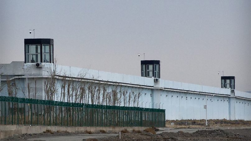 A person stands in a tower on the perimeter of the Number 3 Detention Center in Dabancheng in western China’s Xinjiang Uyghur Autonomous Region on April 23, 2021. Human rights groups and Western nations led by the United States, Britain and Germany accused China of massive crimes against the Uyghur minority and demanded unimpeded access for U.N. experts at a virtual meeting on May 12, 2021. China denounced the demands as “politically motivated” and based on “lies.” (AP Photo/Mark Schiefelbein)