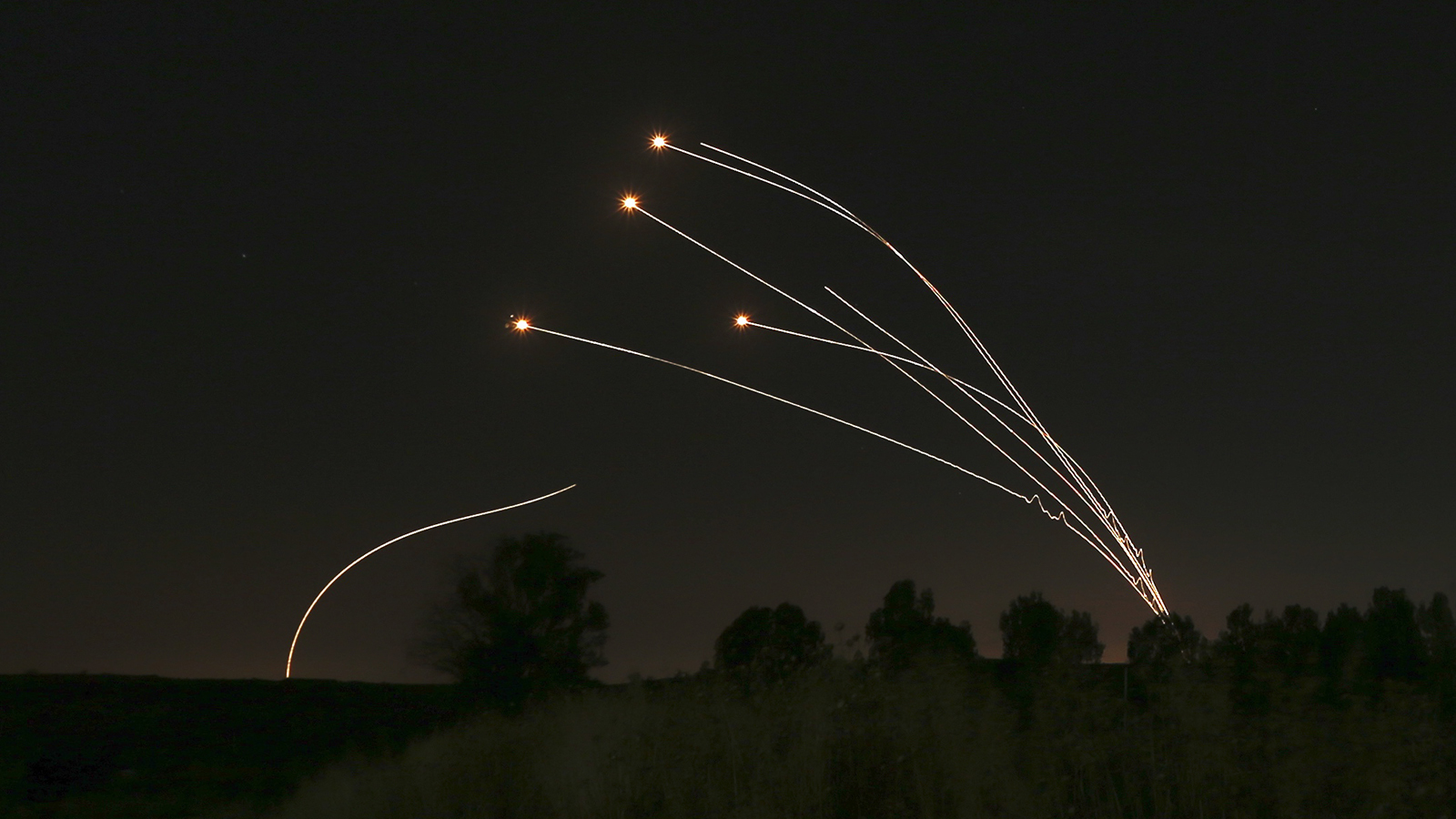 In this May 4, 2019, file photo, Israeli air defense system Iron Dome takes out rockets fired from Gaza near Sderot, Israel. The Israeli Defense Ministry said March 16, 2021, that the Iron Dome air defense system has been upgraded and is now capable for intercepting rocket and missile salvos as well as simultaneous attacks by unmanned aerial vehicles. (AP Photo/Ariel Schalit, File)