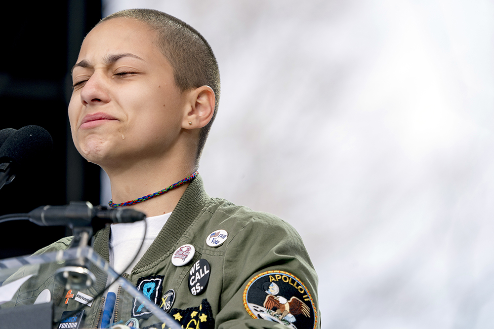 Emma Gonzalez, a survivor of the mass shooting at Marjory Stoneman Douglas High School in Parkland, Florida, closes her eyes and cries as she stands silently at the podium and times the amount of time it took the Parkland shooter to go on his killing spree, during the "March for Our Lives" rally in support of gun control in Washington, Saturday, March 24, 2018. (AP Photo/Andrew Harnik)