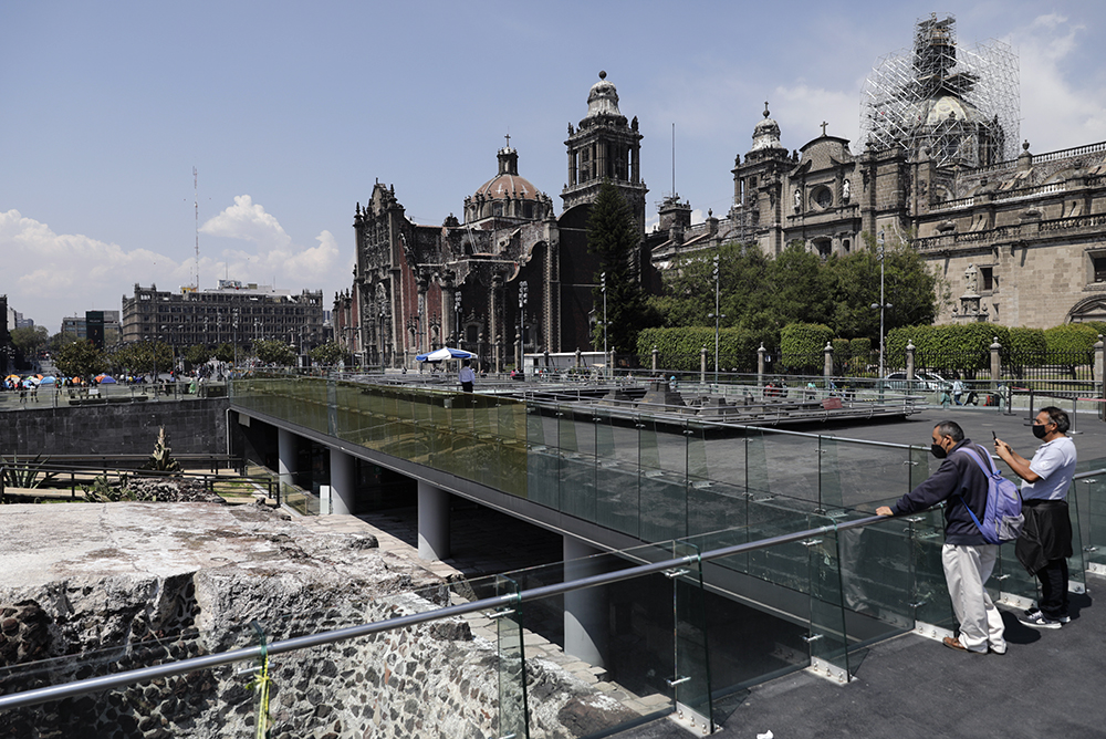 People visit the archaeological site of Templo Mayor in the historic center of Mexico City, Tuesday, May 18, 2021. The Templo Mayor, or "The Greater Temple" in Spanish, was the main temple of the Aztec capital city of Tenochtitlan, now Mexico City, which fell to Spanish Conquistador Hernan Cortes after a prolonged siege 500 years ago. (AP Photo/Eduardo Verdugo)