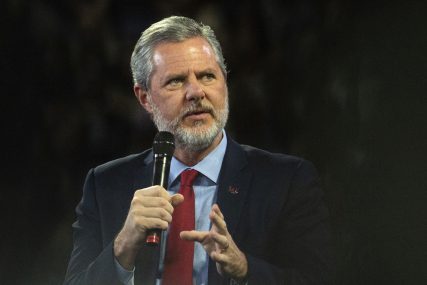 FILE - In this, Nov. 13 2019, file photo, Liberty University President Jerry Falwell Jr. talks to Donald Trump Jr. about his new book "Triggered" during convocation at Liberty University in Lynchburg, Va. Falwell is asking a court in Virginia to dismiss a lawsuit Liberty University filed over his headline-grabbing departure last year as leader of the evangelical school his father founded. (Emily Elconin/The News & Advance via AP, File)