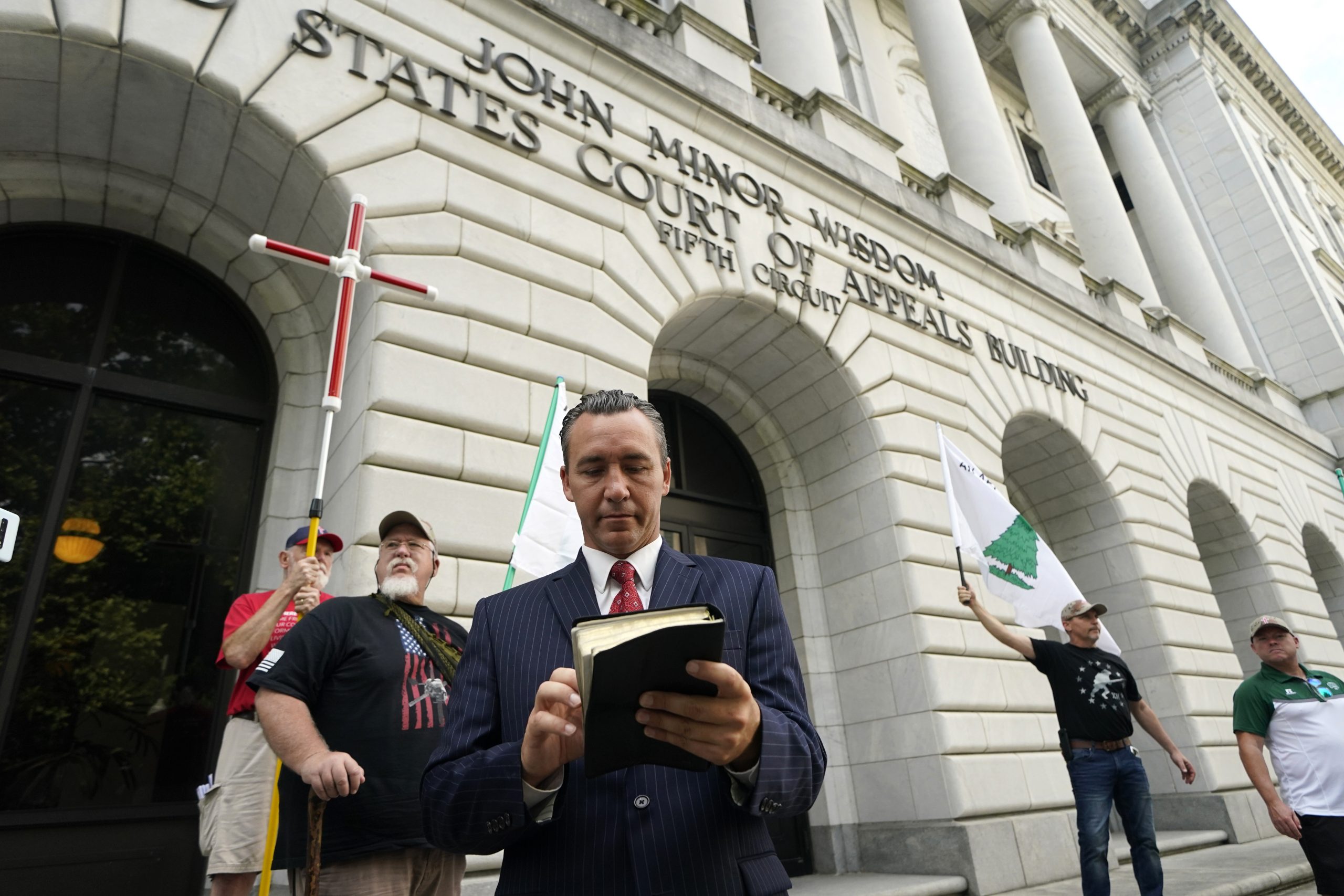 Tony Spell, pastor of the Life Tabernacle Church of Central City, Louisiana, waits outside the 5th Circuit Court of Appeals in New Orleans on June 7, 2021. Spell, who flouted coronavirus restrictions last year, prepared Monday to ask the court to revive his lawsuit challenging the restrictions. (AP Photo/Gerald Herbert)