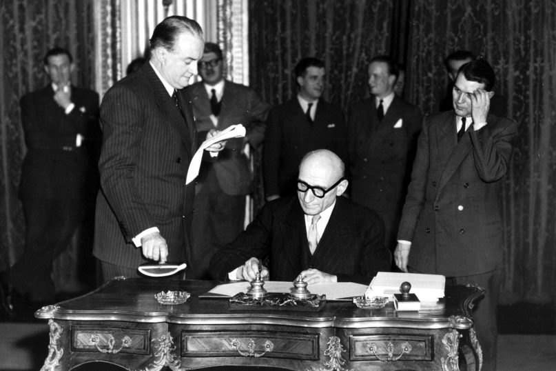 FILE - In this April 18, 1950 file photo, French Foreign Minister Robert Schuman signs a treaty. Pope Francis has put one of the architects of the plan for European integration, a forerunner of the European Union, on the path to possible sainthood. The Vatican said on Saturday, June 19, 2021 that the pontiff authorized a decree declaring the “heroic virtues” of Robert Schuman, a former French minister and Resistance fighter in World War II, who died in 1963 and who had been president of the European Parliament from 1958 till 1960. (AP Photo/1950)
