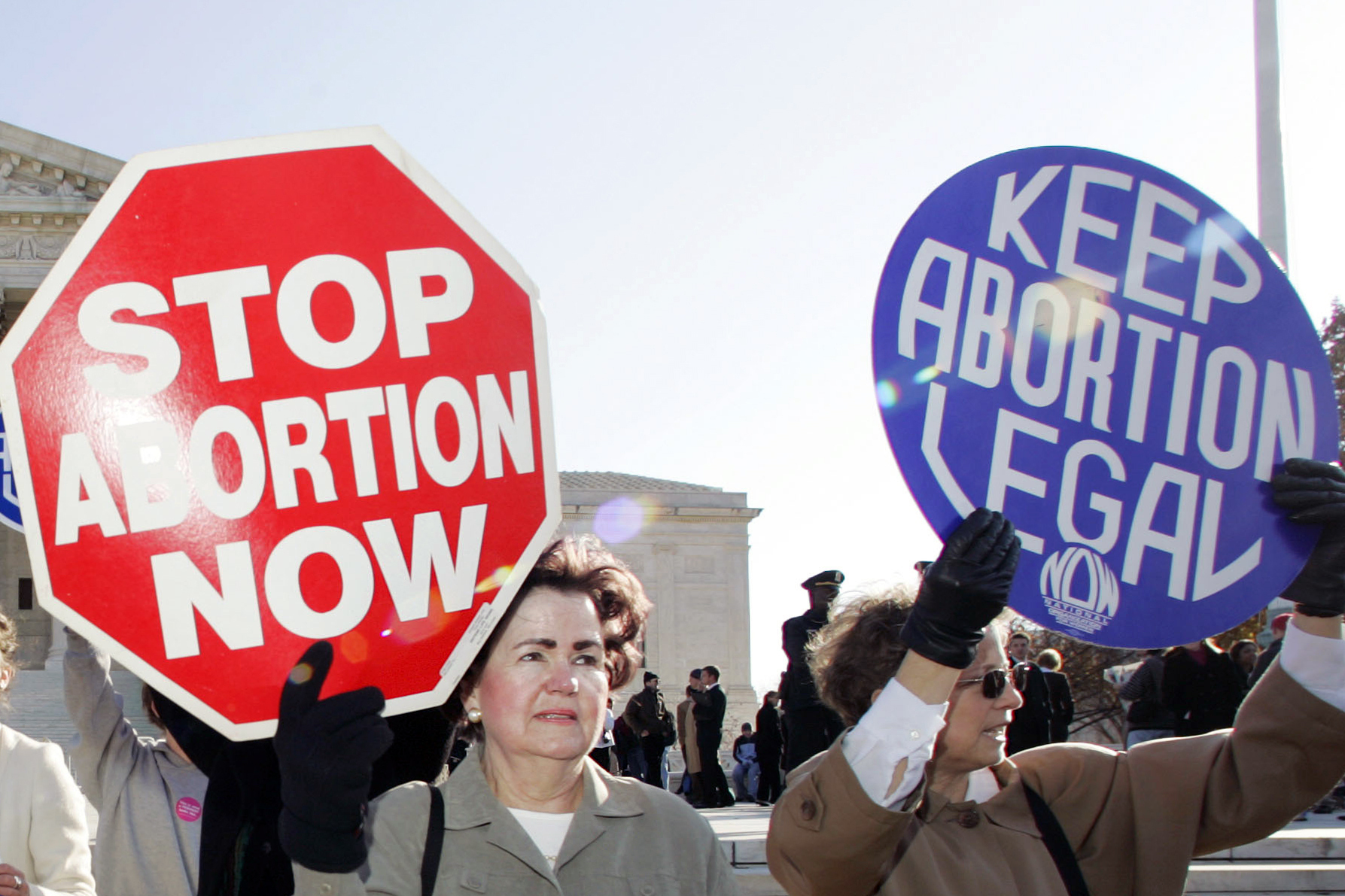 In this Nov. 30, 2005, file photo, an anti-abortion demonstrator stands next to an abortion-rights supporter outside the U.S. Supreme Court in Washington. (AP Photo/Manuel Balce Ceneta)