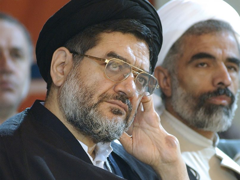 Ali Akbar Mohtashamipour listens to a speaker in a meeting in Tehran, Iran, on Dec. 4, 2003. Mohtashamipour, a Shiite cleric who as Iran's ambassador to Syria helped found the Lebanese militant group Hezbollah and lost his right hand to a book bombing reportedly carried out by Israel, died Monday, June 7, 2021, of the coronavirus. (AP Photo/Vahid Salemi)