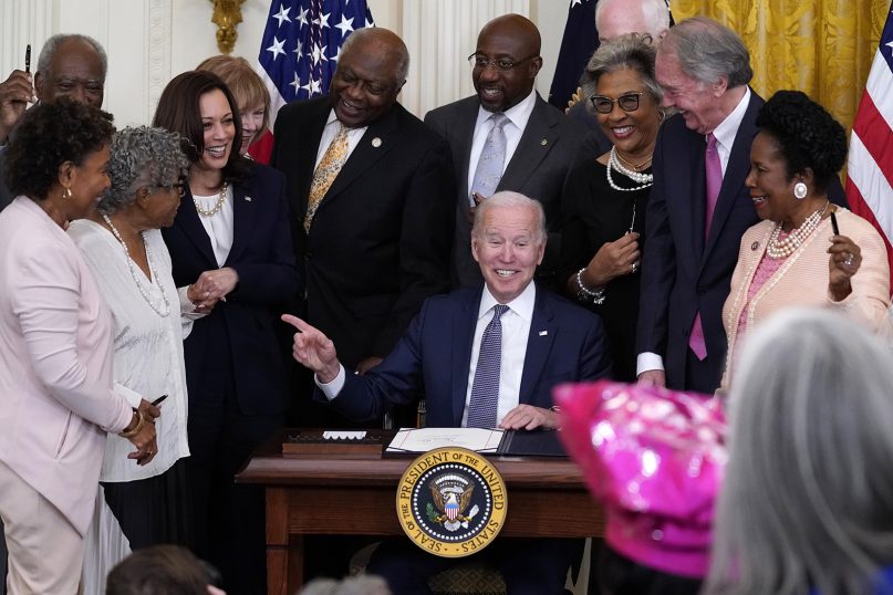President Joe Biden points to Opal Lee after signing the Juneteenth National Independence Day Act, in the East Room of the White House, June 17, 2021, in Washington. From left, Rep. Barbara Lee, D-Calif.; Rep. Danny Davis, D-Ill.; Opal Lee; Vice President Kamala Harris; Sen. Tina Smith, D-Minn.;  House Majority Whip James Clyburn of South Carolina; Sen. Raphael Warnock, D-Ga.; Sen. John Cornyn, R-Texas, obscured; Rep. Joyce Beatty, D-Ohio; Sen. Ed Markey, D-Mass.; and Rep. Sheila Jackson Lee, D-Texas. (AP Photo/Evan Vucci)