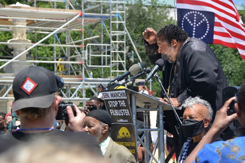 Rev. William Barber II raises his fist while speaking at the protest against the current filibuster on Wednesday afternoon, June 23, 2021 in front of the Supreme Court. RNS photo by Jack Jenkins