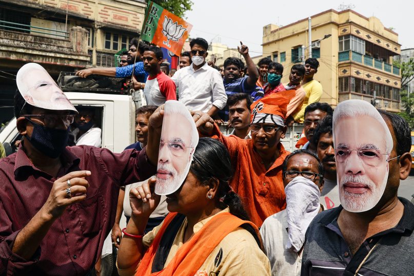 In this March 20, 2021, file photo, supporters of Bharatiya Janata Party wear masks bearing the likeness of Prime Minister Narendra Modi during a campaign rally ahead of elections in West Bengal state in Kolkata, India. (AP Photo/Bikas Das, File)