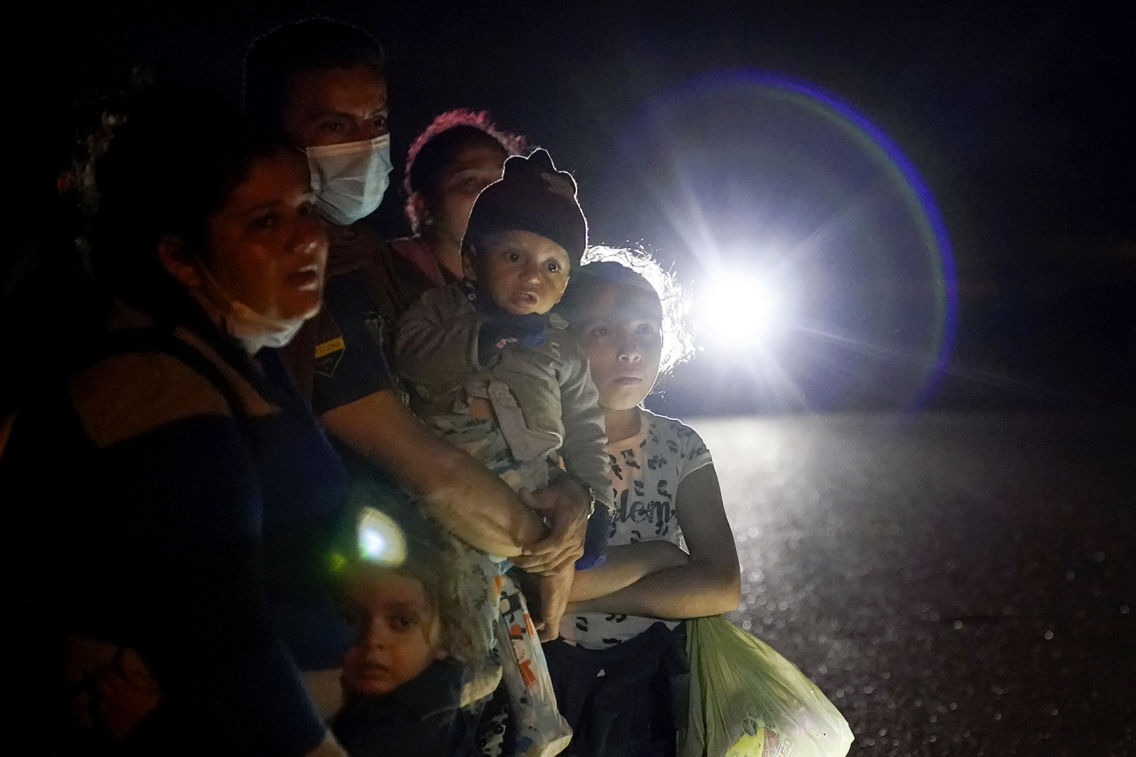 A group of migrants mainly from Honduras and Nicaragua wait along a road after turning themselves in upon crossing the U.S.-Mexico border, in La Joya, Texas, May 17, 2021. The Biden administration announced Tuesday, June 15, 2021, that it was expanding a newly-revived effort to bring Central American children to the United States to reunite with parents legally living in the country. (AP Photo/Gregory Bull, File)