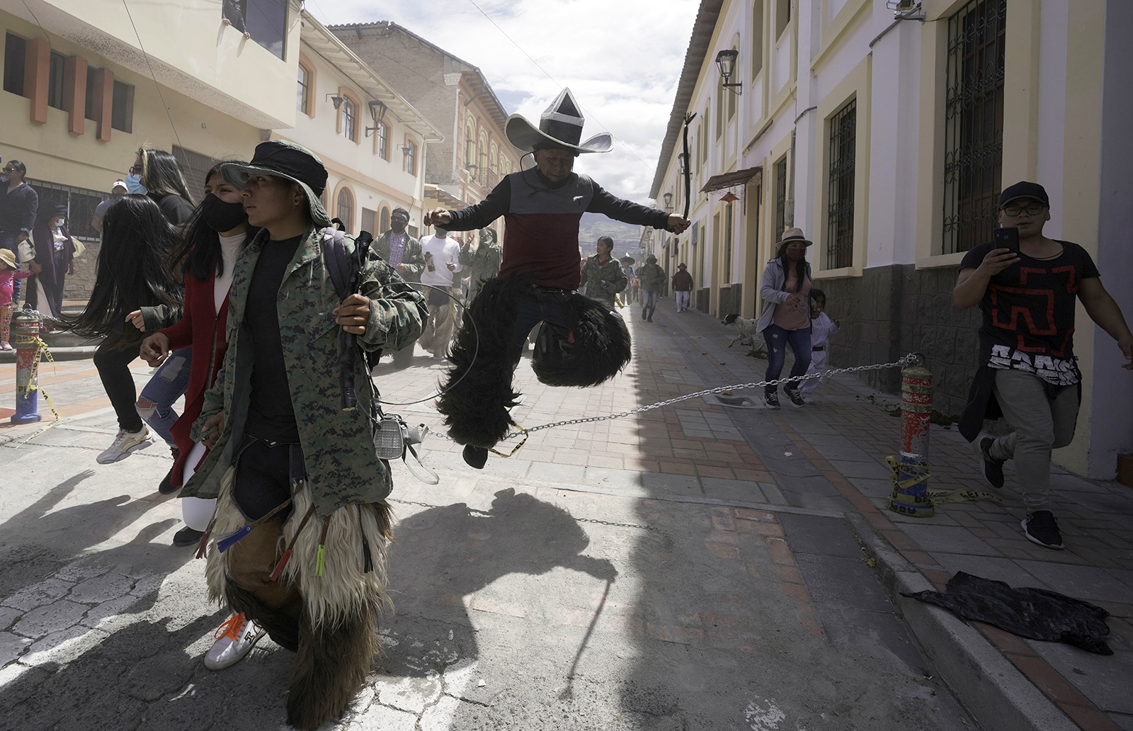 Revelers dance during the "Inti Raymi," or Sun Festival celebrations, despite restrictions to prevent the spread of the new coronavirus, in Cotacachi, Ecuador, Thursday, June 24, 2021. Across the Andes, from the tip of Argentina as far north as Colombia, indigenous communities gather in June for the southern hemisphere's winter solstice to pay homage to Inti, the ancient Incan sun god, in hopes of being granted a plentiful harvest. (AP Photo/Dolores Ochoa)