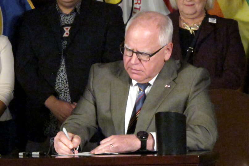 Minnesota Gov. Tim Walz signs a ban on so-called conversion therapy during a ceremony at the State Capitol in St. Paul, Minn., on Thursday, July 15, 2021. Walz said conversion therapy, the scientifically discredited practice of using therapy to 