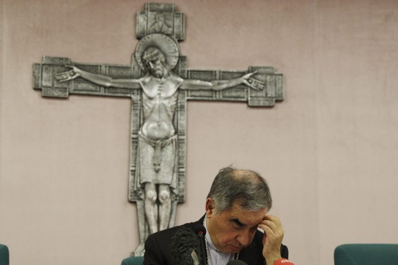 In this Sept. 25, 2020, file photo, Cardinal Angelo Becciu looks down as he meets the media during a news conference in Rome. The Vatican's criminal tribunal indicted 10 people July 3, 2021, including Becciu, and four companies on charges including extortion, abuse of office and fraud in connection with the secretariat of state's 350 million-euro investment in a London real estate venture. Becciu helped engineer the initial London investment when he was the chief of staff in the secretariat of state. (AP Photo/Gregorio Borgia, File)