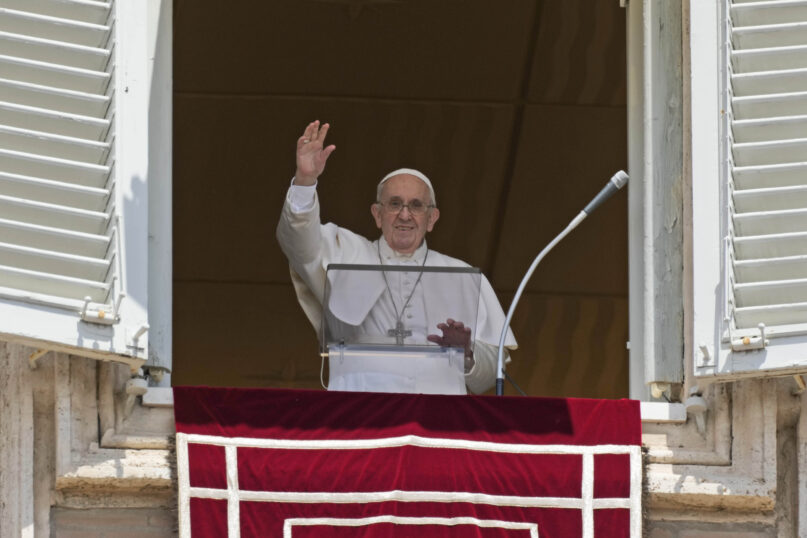 Pope Francis salutes the crowd as he arrives for the Angelus noon prayer from the window of his studio overlooking St. Peter's Square, at the Vatican, July 18, 2021. (AP Photo/Alessandra Tarantino)