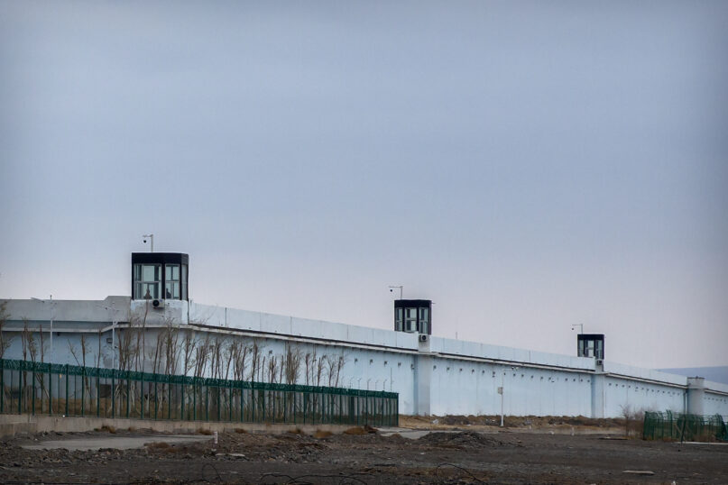 People stand in a guard tower on the perimeter wall of the Urumqi No. 3 Detention Center in Dabancheng in western China's Xinjiang Uyghur Autonomous Region on April 23, 2021. China's largest detention center is twice the size of Vatican City and has room for at least 10,000 inmates. (AP Photo/Mark Schiefelbein)