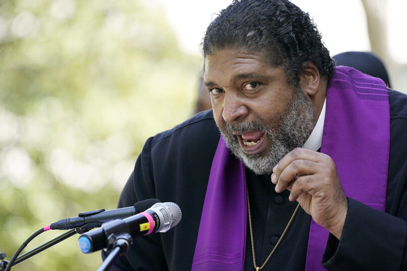 Rev. William J. Barber II, national co-chair of the Poor People's Campaign, tells a gathering in downtown Jackson, Miss., that restoring voting rights to people who have finished serving time is a moral imperative, Monday, April 19, 2021. On Wednesday, July 28, Barber will help lead a four-day, 27-mile march from Georgetown to Austin, Texas to talk about voting rights.  (AP Photo/Rogelio V. Solis)