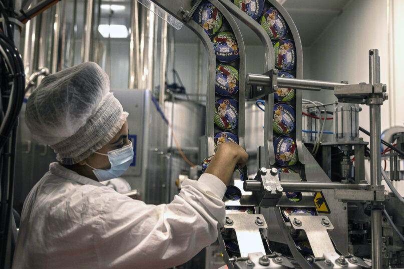 An Israeli works at the Ben & Jerry’s ice cream factory in the Be’er Tuvia Industrial area, July 20, 2021. (AP Photo/Tsafrir Abayov)