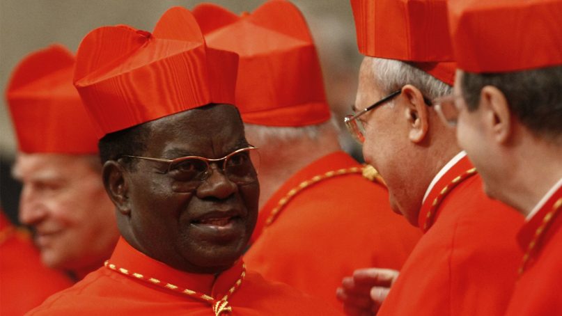 In this Nov. 20, 2010, file photo, newly appointed Cardinal Laurent Monsengwo Pasinya, of Congo, left, is congratuled by other cardinals after being elevated by Pope Benedict XVI during a consistory inside St. Peter’s Basilica, at the Vatican. (AP Photo/Pier Paolo Cito)