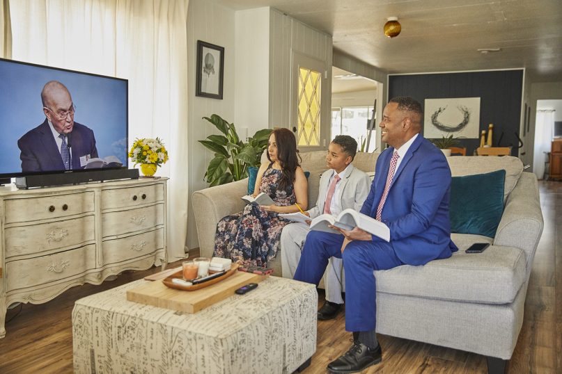 The Hill family watches services on their TV for a baptism during digital services in 2020. Photo courtesy of Jehovah’s Witness