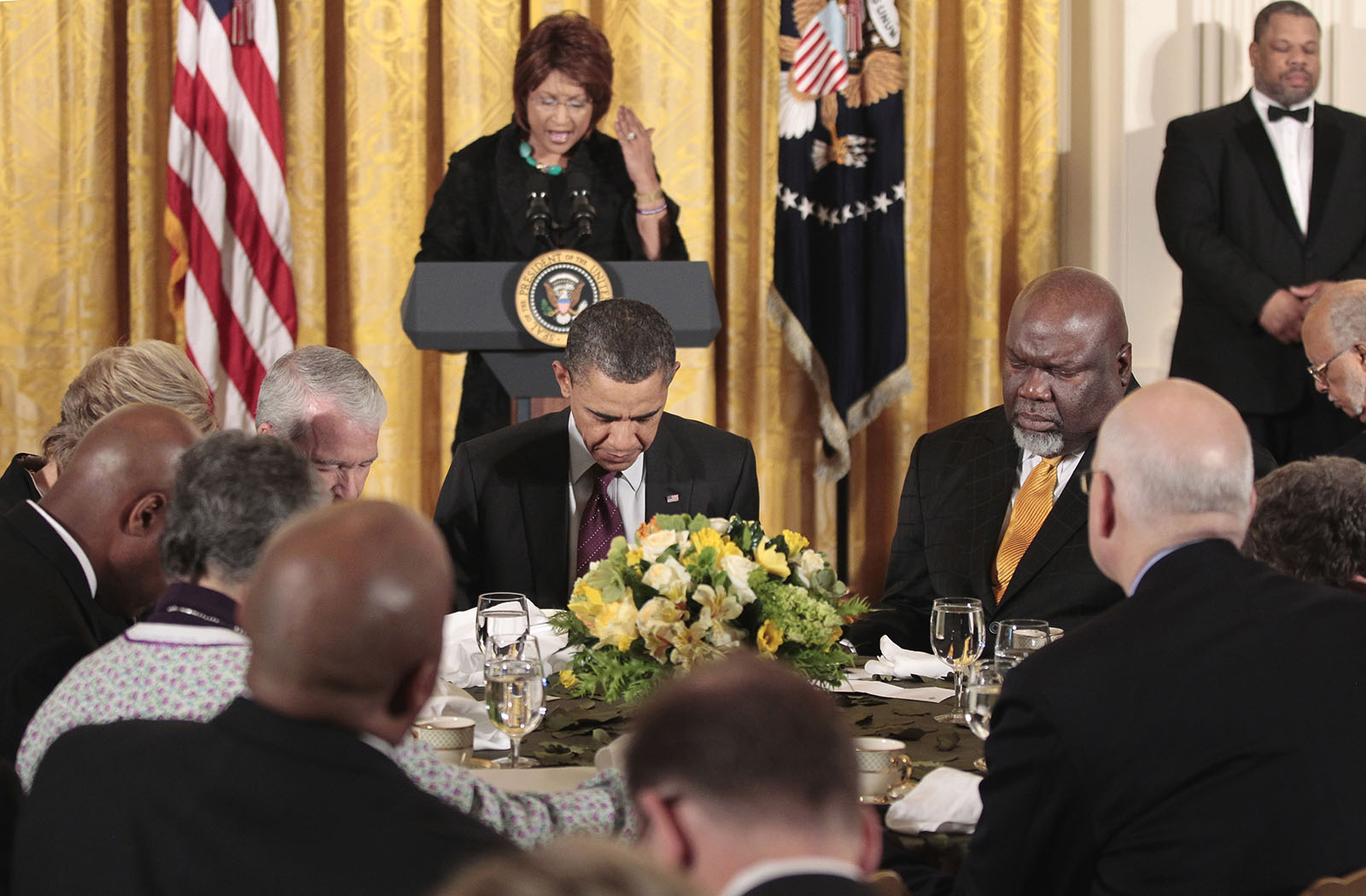 President Barack Obama, center seated, and others, lower their heads during a Easter Prayer breakfast with Christian leaders in the East Room of the White House, Tuesday, April 19, 2011. Leading the prayer behind Obama is Bishop Vashti Murphy McKenzie, of the African Methodist Episcopal Church, and seated to the right of Obama is Texas-based evangelist Bishop T.D. Jakes. (AP Photo/Pablo Martinez Monsivais)