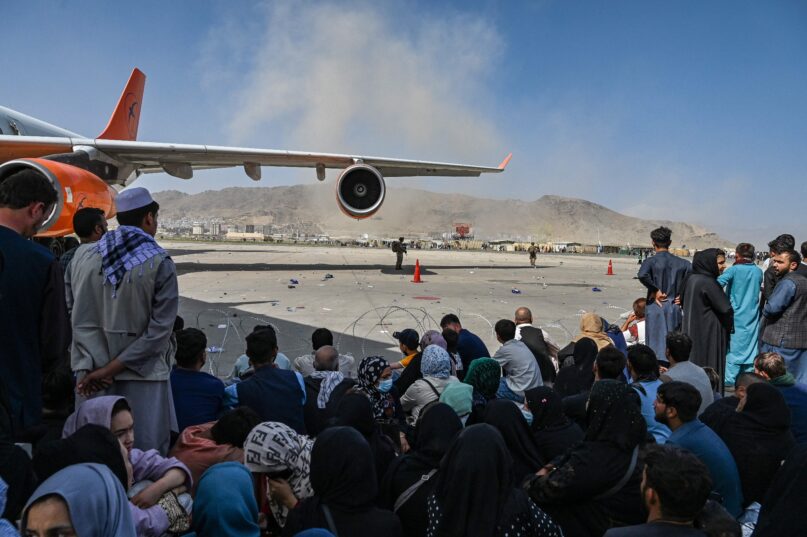 Thousands of Afghans rushed to Kabul's airport trying to flee the country as the Taliban seized power. (Wakil Kohsar / AFP via Getty Images)