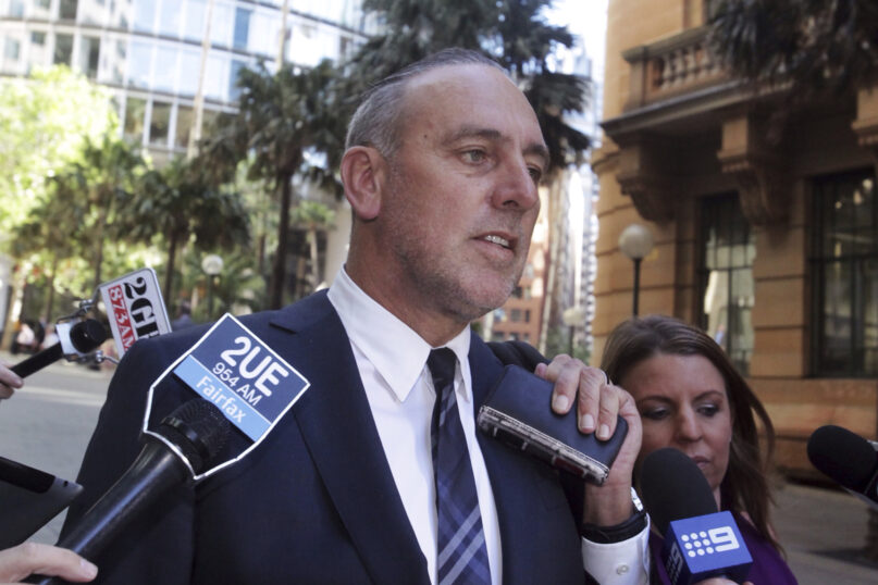 In this Oct. 7, 2014, photo, the founder of the Sydney-based global Hillsong Church, Brian Houston, leaves a Royal Commission into Institutional Responses to Child Sexual Abuse hearing in Sydney, Australia. Houston has been charged with concealing child sex offenses, police said on Aug. 5, 2021. (Mick Tsikas/AAP Image via AP)