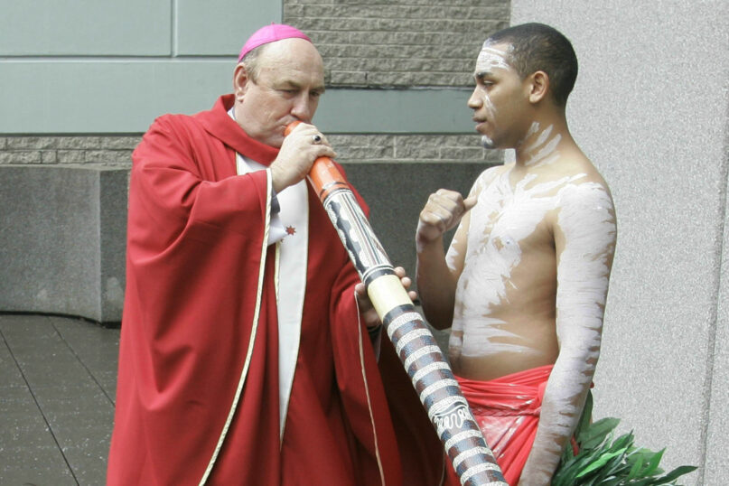 In this April 17, 2008, file photo, Bishop Christopher Saunders of Broome tries to play a digeridoo during a World Youth Day 2008 media event in Sydney, Australia. (AP Photo/Rob Griffith)