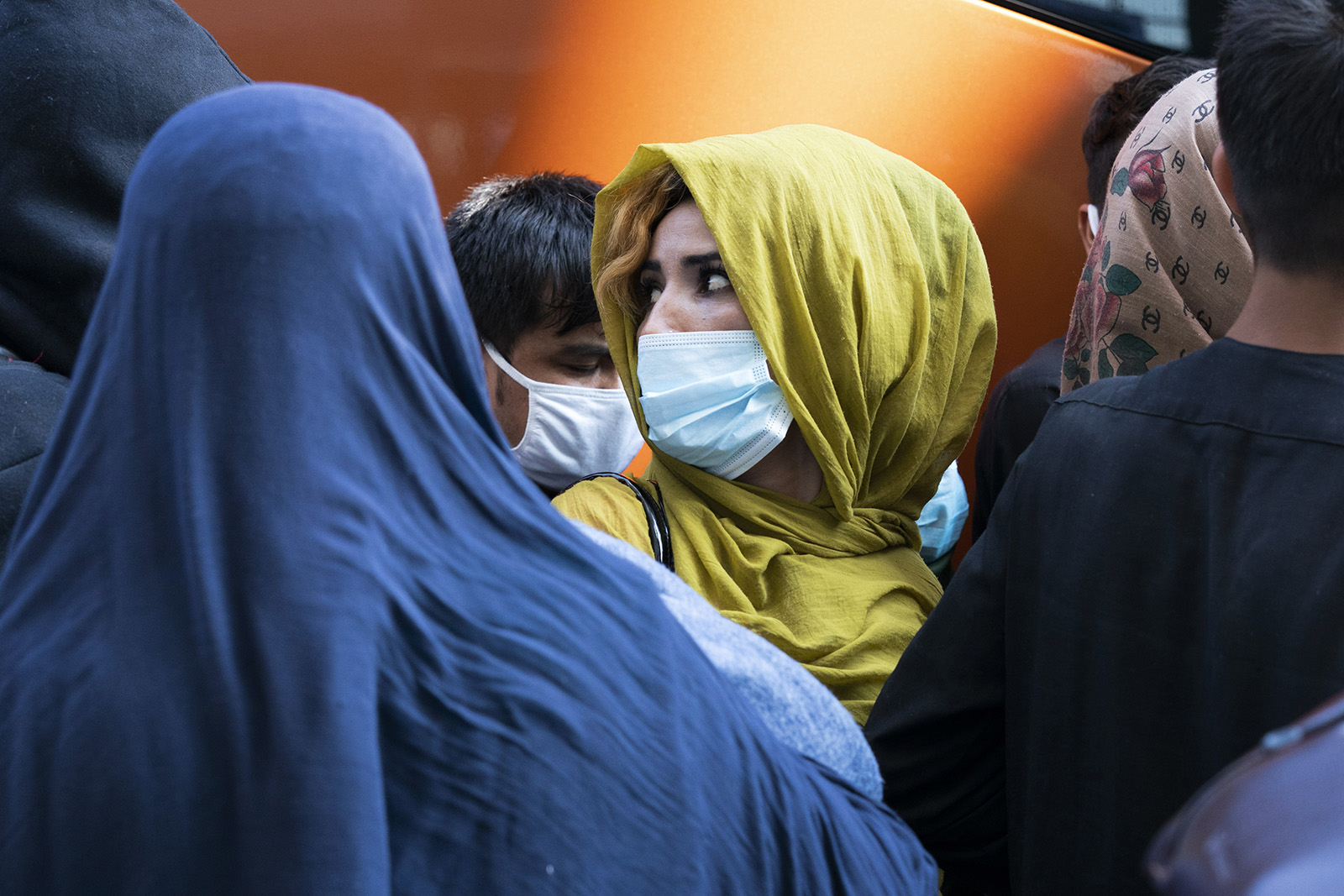 People evacuated from Kabul, Afghanistan, wait to board a bus after they arrived at Washington Dulles International Airport, in Chantilly, Va., on Wednesday, Aug. 25, 2021. (AP Photo/Jose Luis Magana)