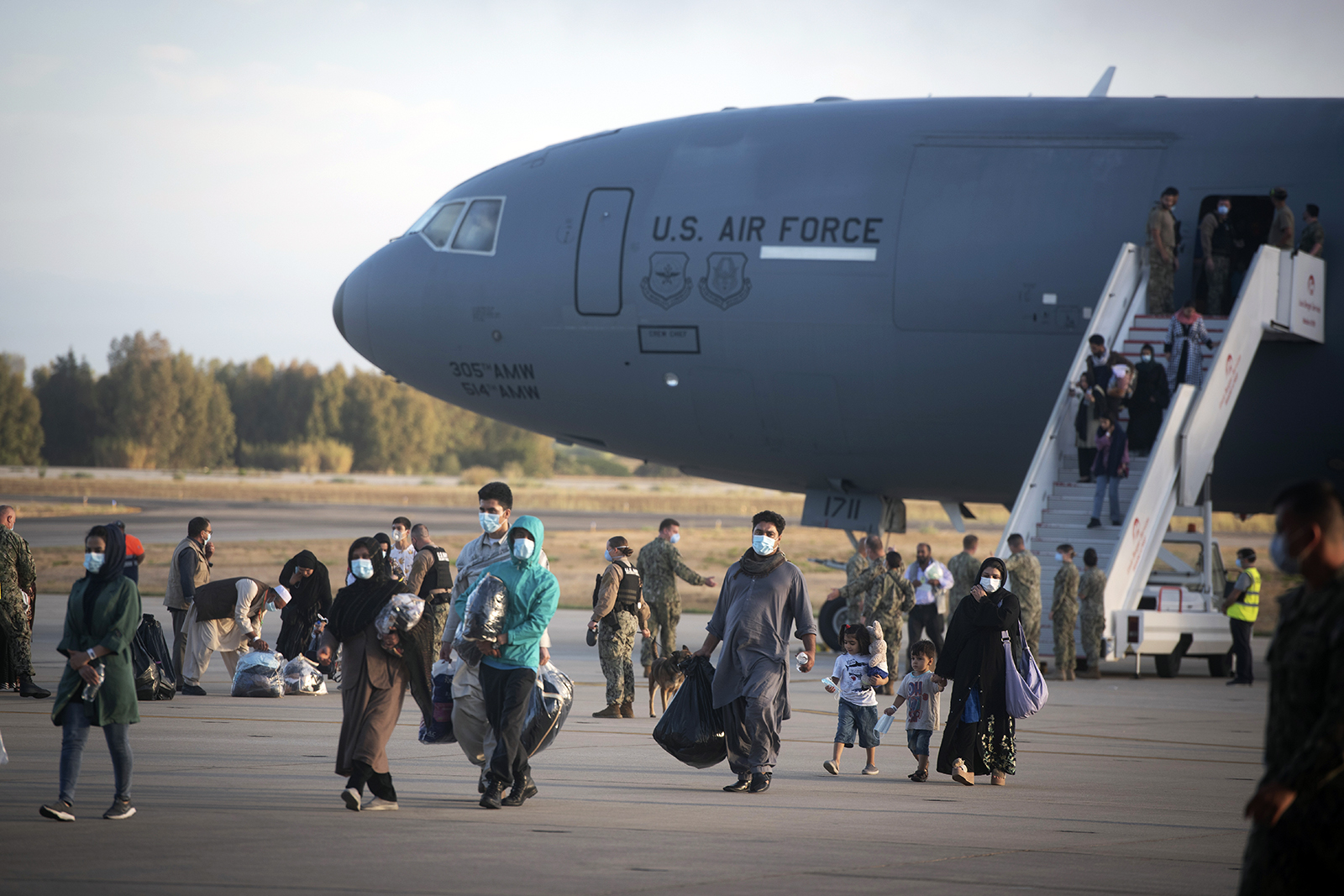 Evacuees from Afghanistan disembark from a U.S. Air Force plane at the naval station in Rota, southern Spain, on Aug. 31, 2021. The United States completed its withdrawal from Afghanistan late Monday, ending America’s longest war. (AP Photo/ Marcos Moreno)