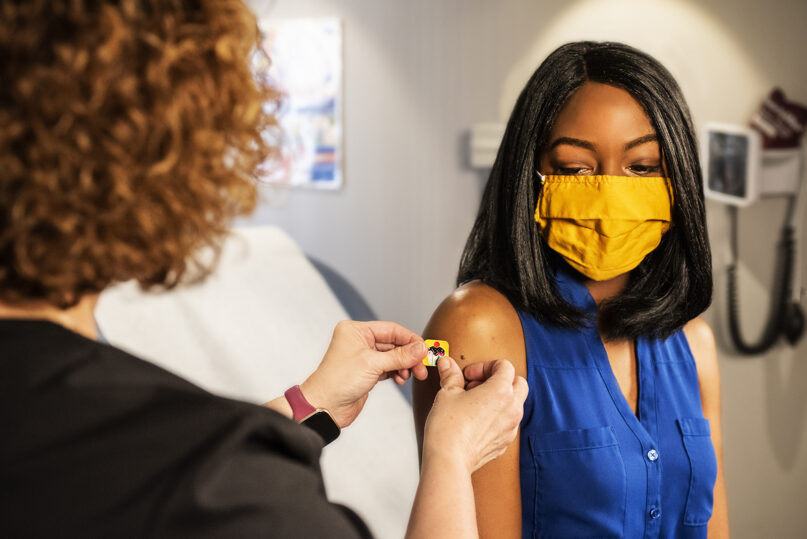 Stock photo of a patient getting a bandage after receiving a shot. Photo by CDC/Creative Commons