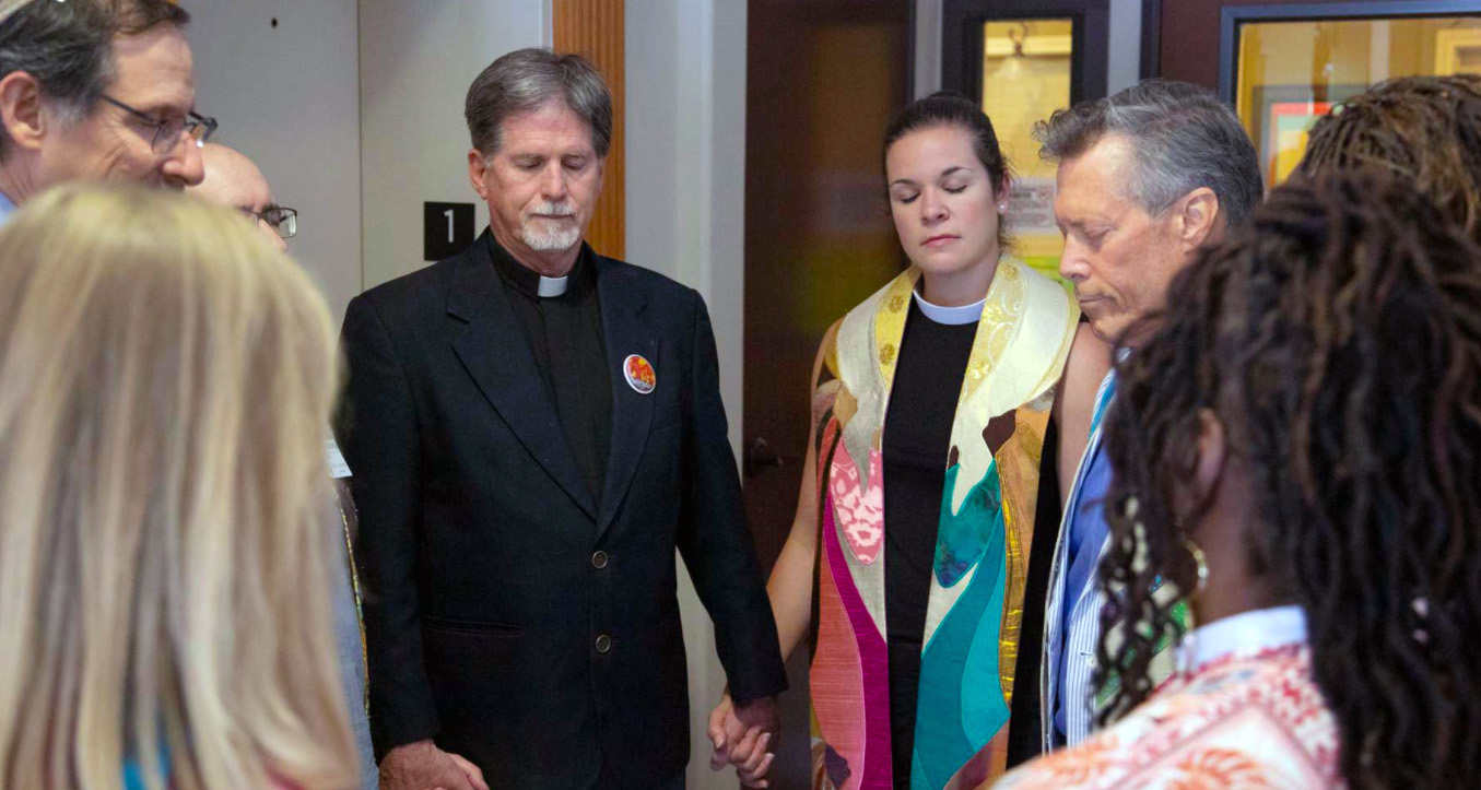 Clergy members hold hands during the blessing of a Whole Woman's Health clinic in Austin, Texas. Photo courtesy of Just Texas