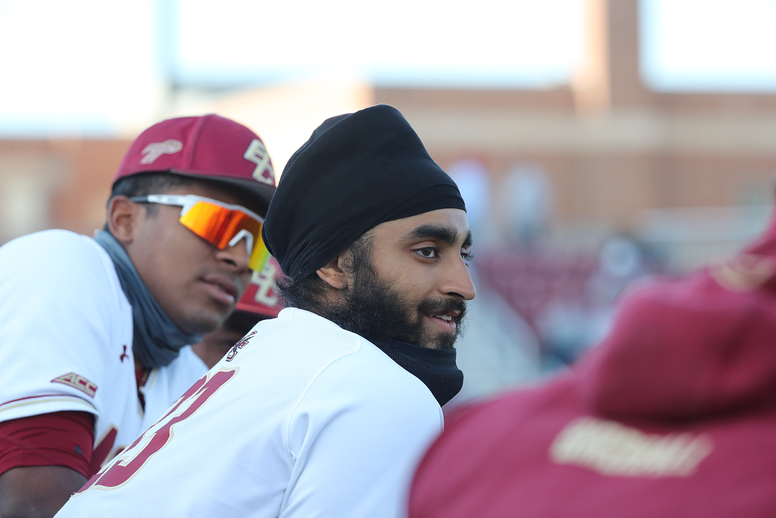 Boston College senior Samrath Singh, center, talks with teammates in the dugout during a game in April 2021. Photo courtesy of Boston College Athletics
