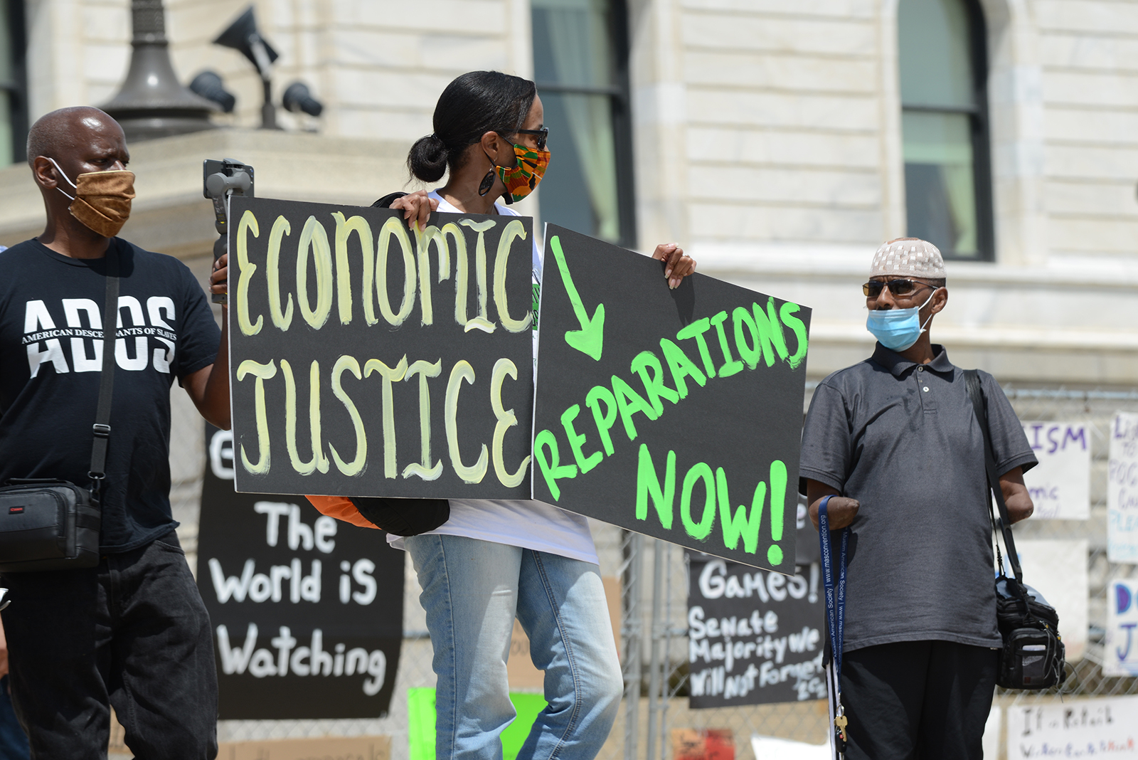 People demonstrate outside the Minnesota capitol building on Juneteenth to demand reparations from the United States government for years of slavery, Jim Crow, segregation, redlining, and violence against black people from police, on June 19, 2020, in St. Paul, Minnesota. Photo by Fibonacci Blue/Creative Commons