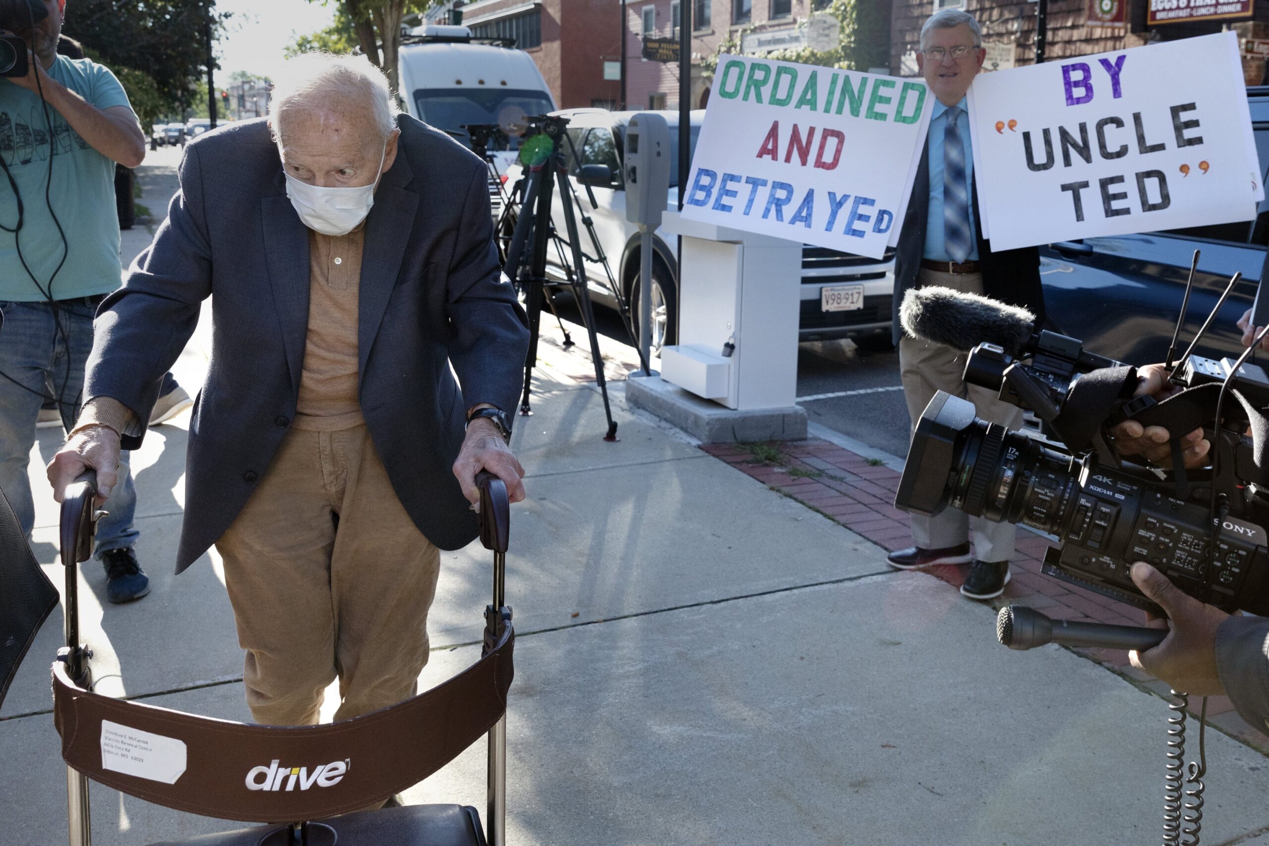Former Cardinal Theodore McCarrick, left, arrives at Dedham District Court, Friday, Sept. 3, 2021, in Dedham, Mass. McCarrick, the once-powerful American prelate who was expelled from the priesthood for sexual abuse, pleaded not guilty Friday to sexually assaulting a 16-year-old boy during a wedding reception in Massachusetts nearly 50 years ago. (AP Photo/Michael Dwyer)